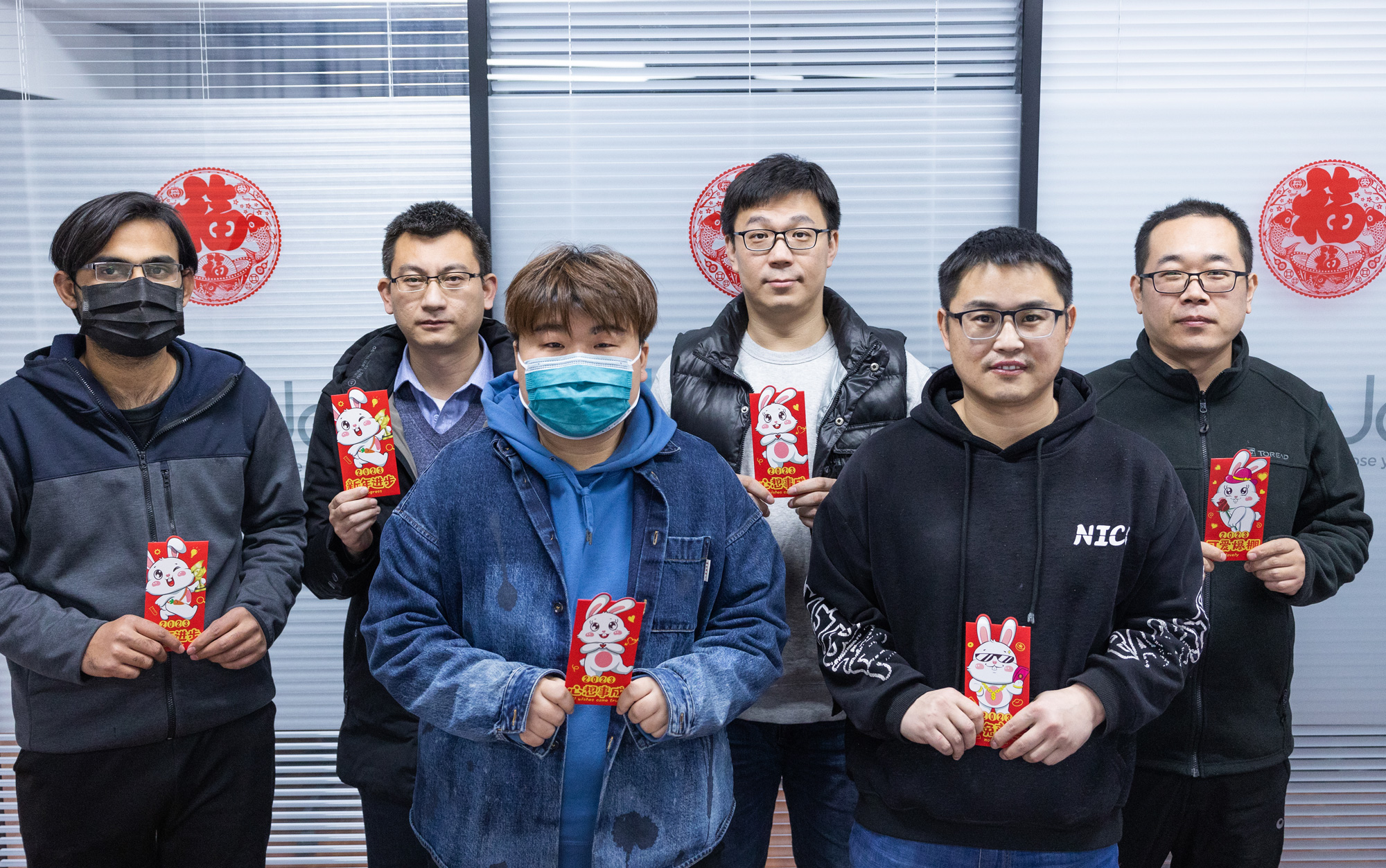 team member celebrating CNY with red envelopes